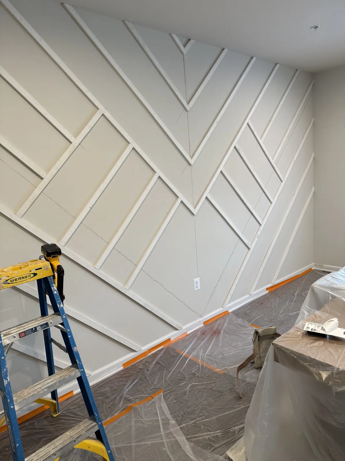 Interior accent wall remodeling: geometric wood trim layout before paint, Northern VA home